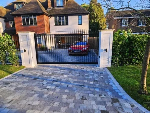 automatic metal gate across brick driveway