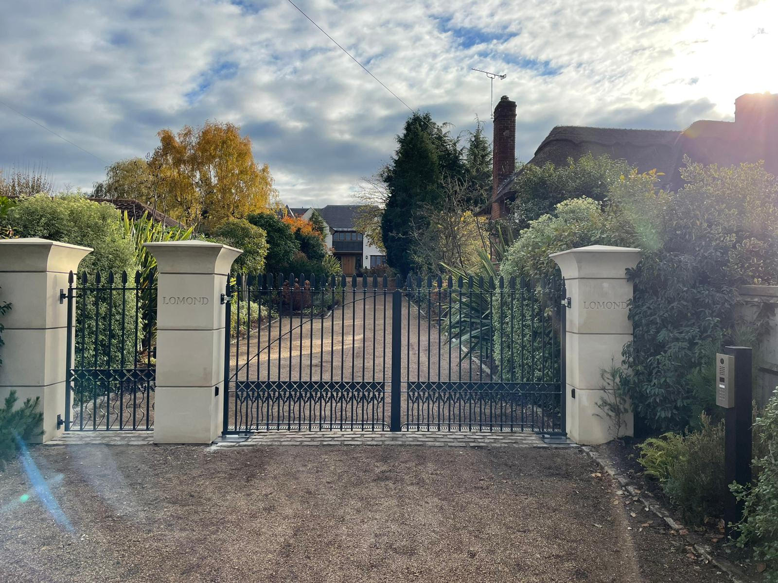 electric metal gates with brick pillars