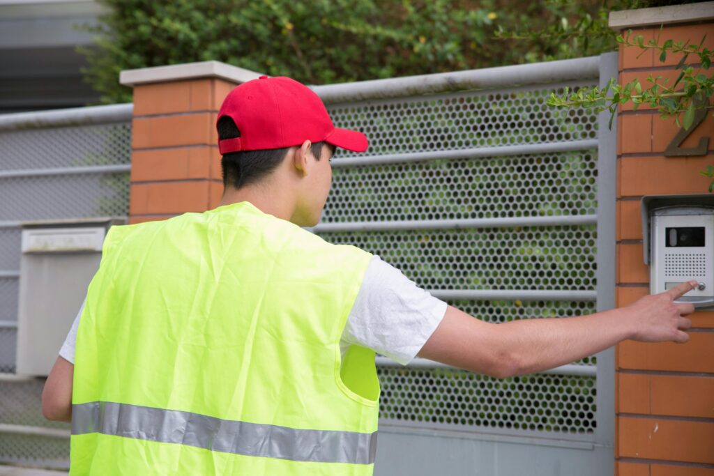 delivery driver at electric gate using intercom